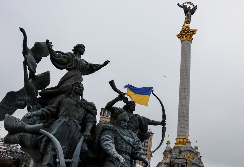 FILE PHOTO: Drone carrying a Ukrainian national flag flies past