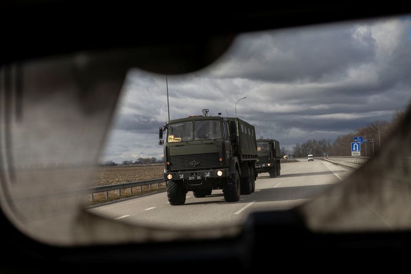 Military truck drive along a highway east of Kyiv