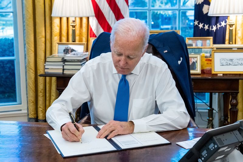 U.S. President Joe Biden signs an executive order, in Washington