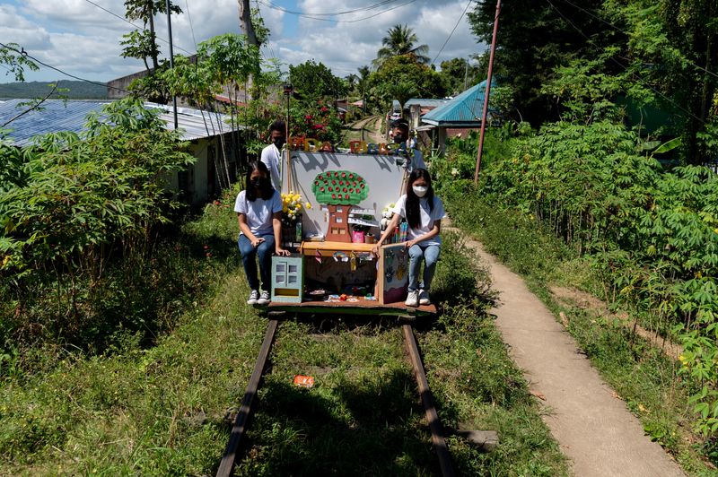 Student volunteers organize mobile library in a makeshift trolley