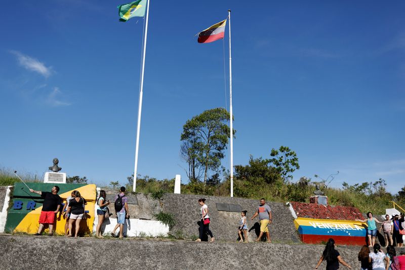 FILE PHOTO: People stand at the border with Venezuela, seen