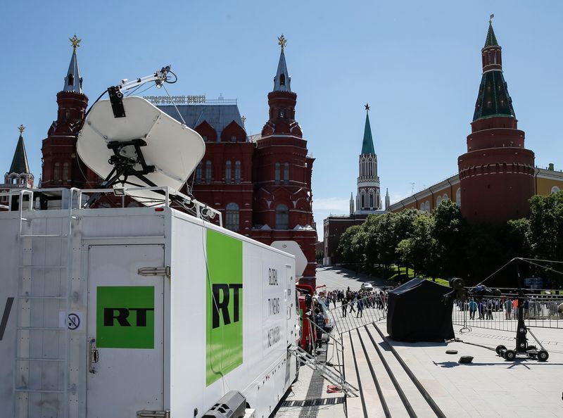 Vehicles of Russian state-controlled broadcaster Russia Today are seen near