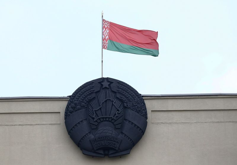 Belarusian state flag and emblem are seen on a building