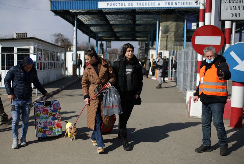 People flee from Ukraine to Romania at the border crossing,