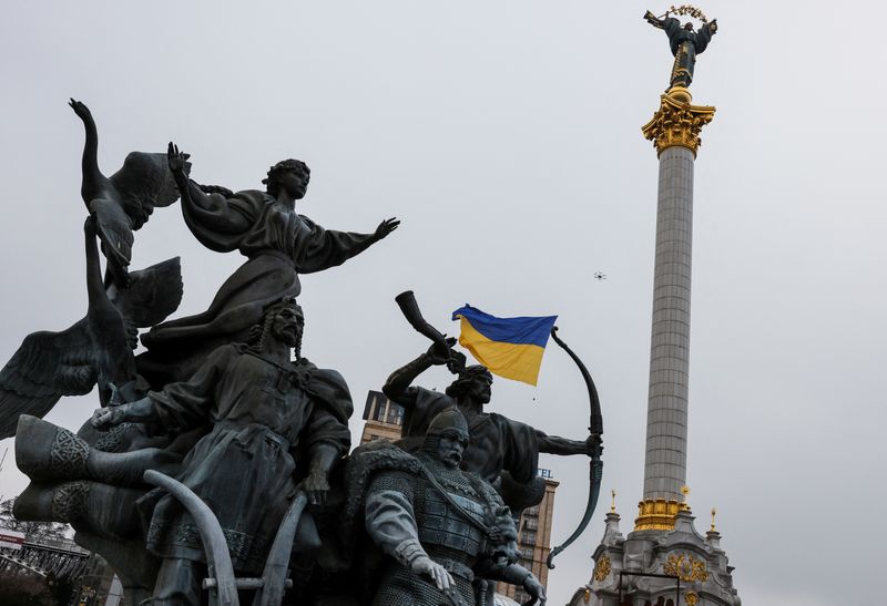A drone carrying a Ukrainian national flag flies past Independence