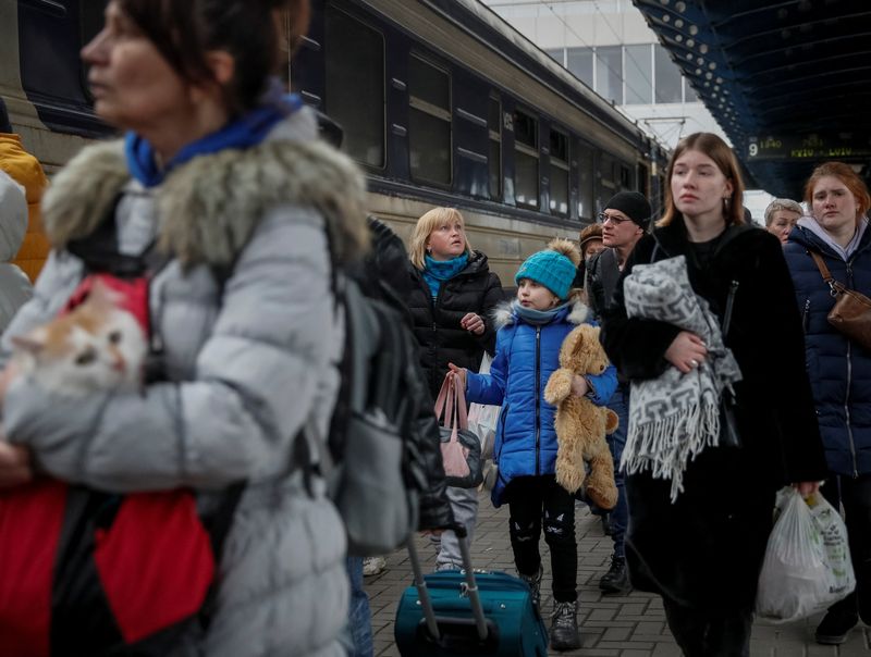 People board an evacuation train at Kyiv central train station