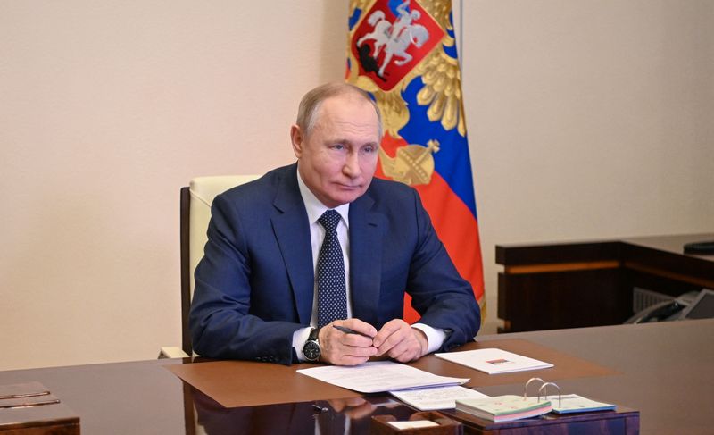 Russian President Putin takes part in a video link outside