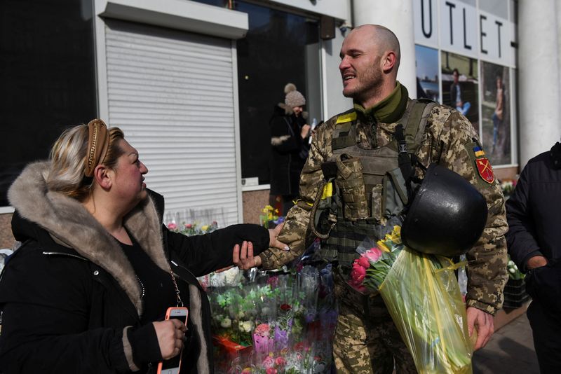 Ukrainian soldier Dmitriy, 32, is greeted by a woman after