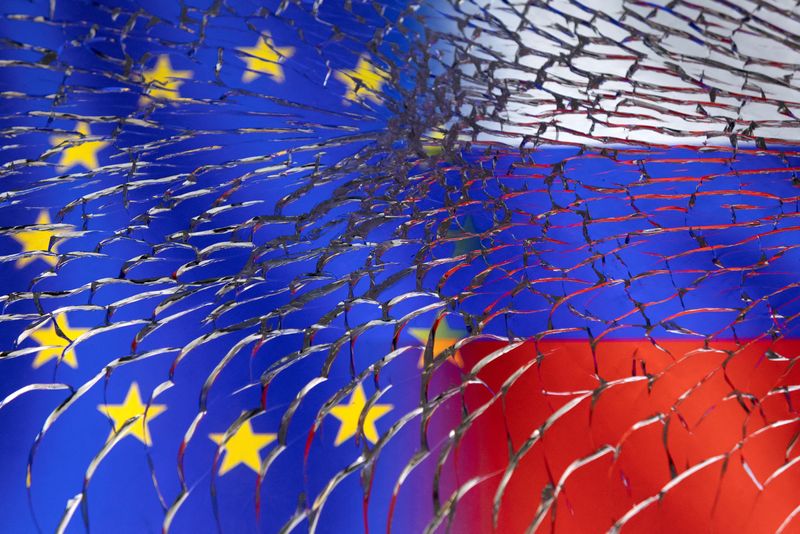 Illustration shows EU and Russian flags through broken glass