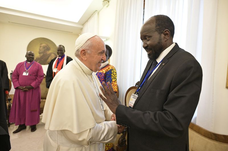 Pope Francis shakes hands with the President of South Sudan