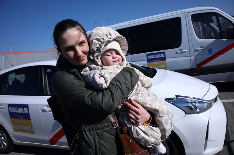 Ukrainian woman Olga, 38, holds her 6-month-old daughter Vera in