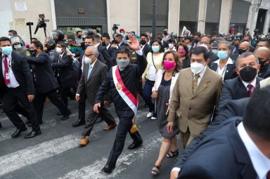 Peru’s President Pedro Castillo waves as he walks a day