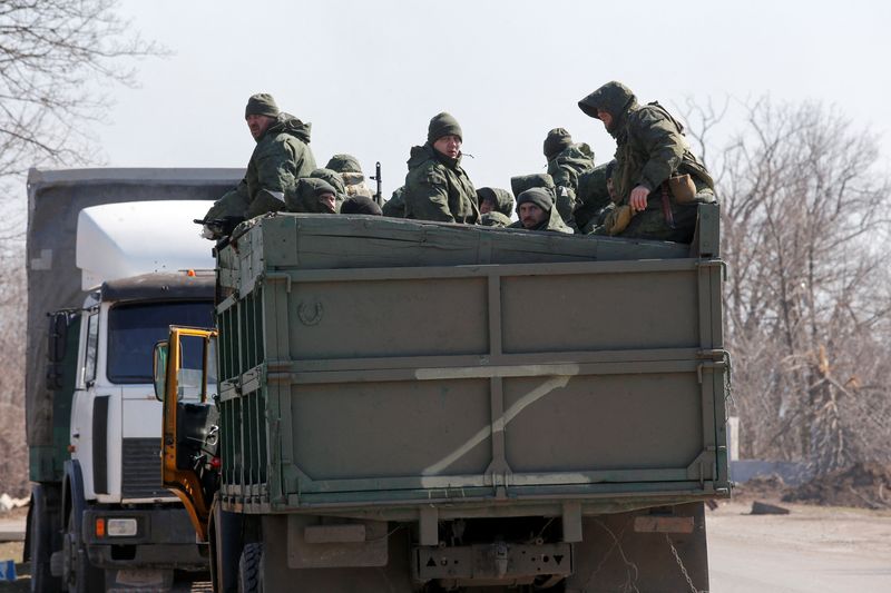 Service members of pro-Russian troops are seen near the besieged