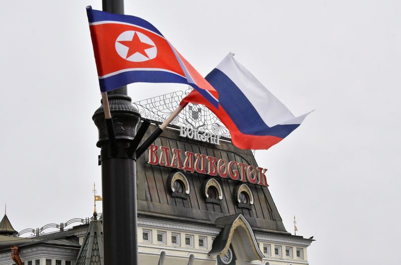 FILE PHOTO: State flags of Russia and North Korea fly