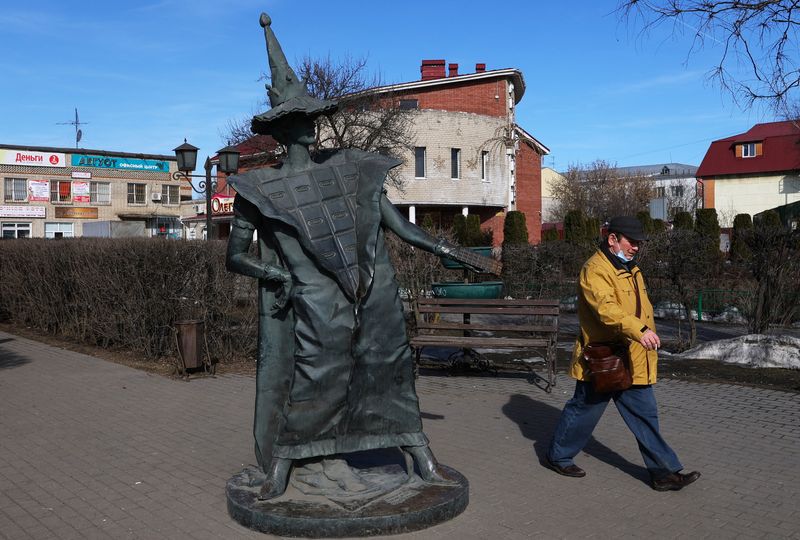 A man walks past the statue “Chocolate fairy” in Pokrov
