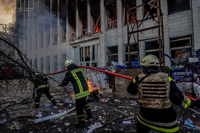 Rescuers work at a site of an industrial building damaged