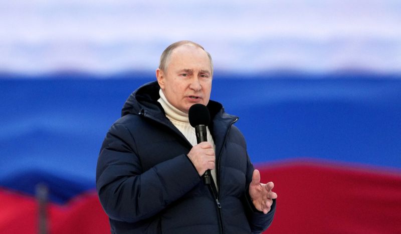 Russian President Vladimir Putin attends a concert marking the eighth