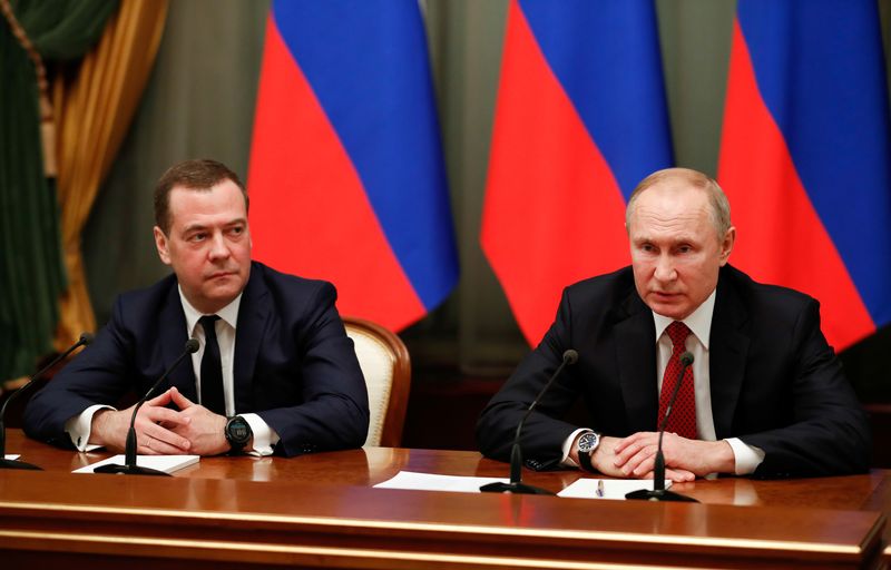 Russian President Putin and Prime Minister Medvedev attend a meeting