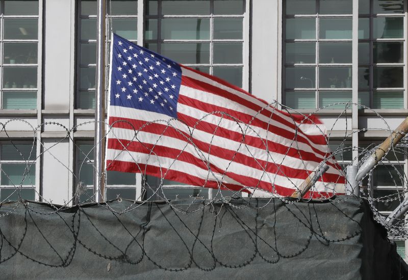 FILE PHOTO: A flag flies behind an enclosure on the
