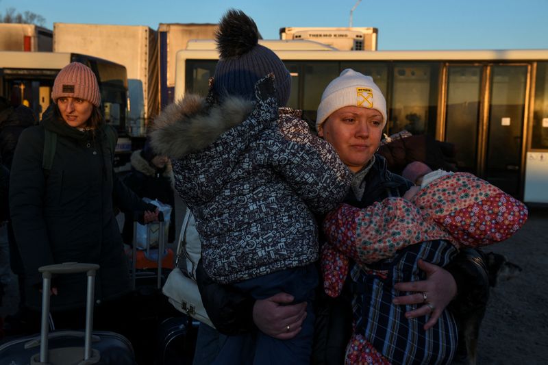 Civilians fleeing Russia’s invasion of Ukraine, arrive on a bus
