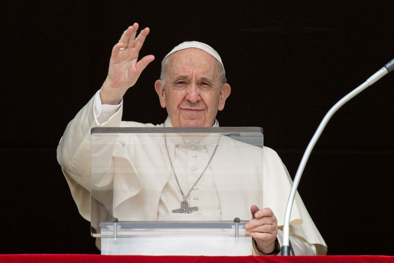 Pope Francis leads the Angelus prayer from the window of