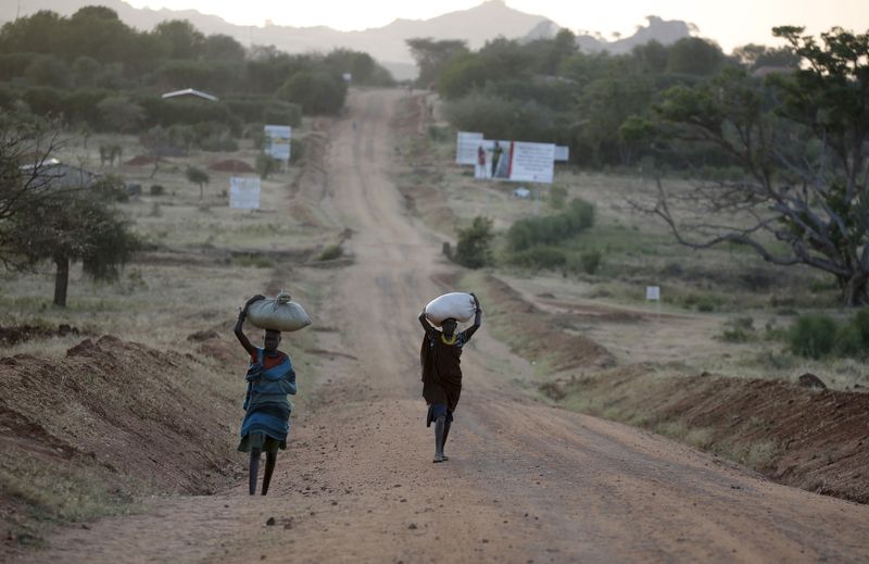 FILE PHOTO: Women carry their belongings outside town of Kaabong