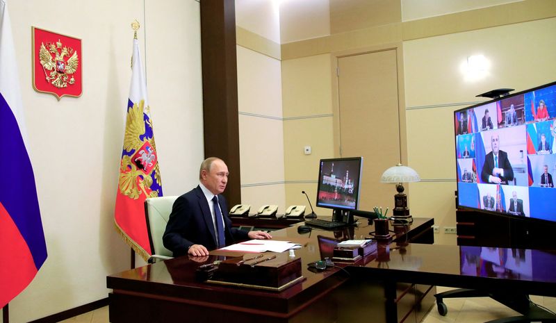 FILE PHOTO: Russian President Putin chairs a meeting with members