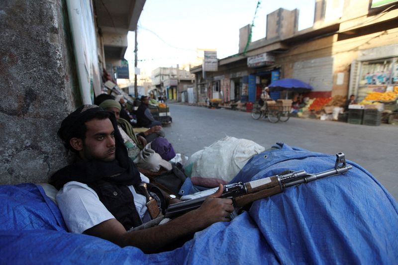FILE PHOTO: A Houthi fighter sits behind sandbags near a