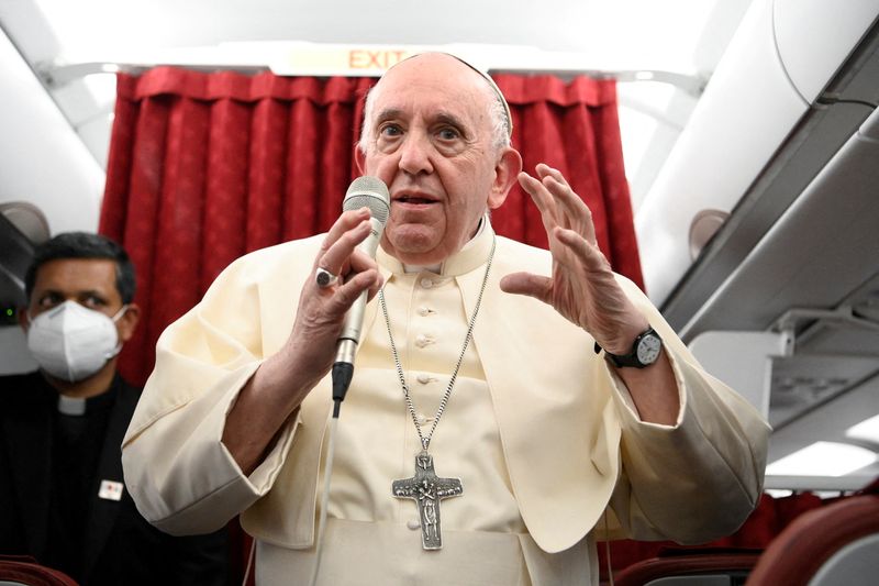 Pope Francis holds a news conference aboard the papal plane