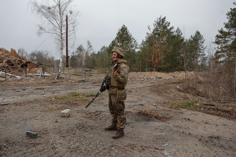 FILE PHOTO: A Ukrainian service member patrols an area in