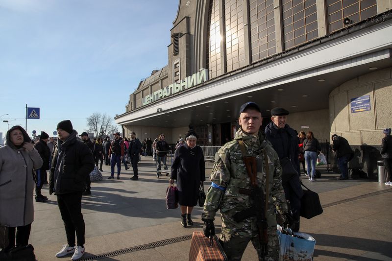People make their way outside the Kyiv-Pasazhyrskyi railway station, amid