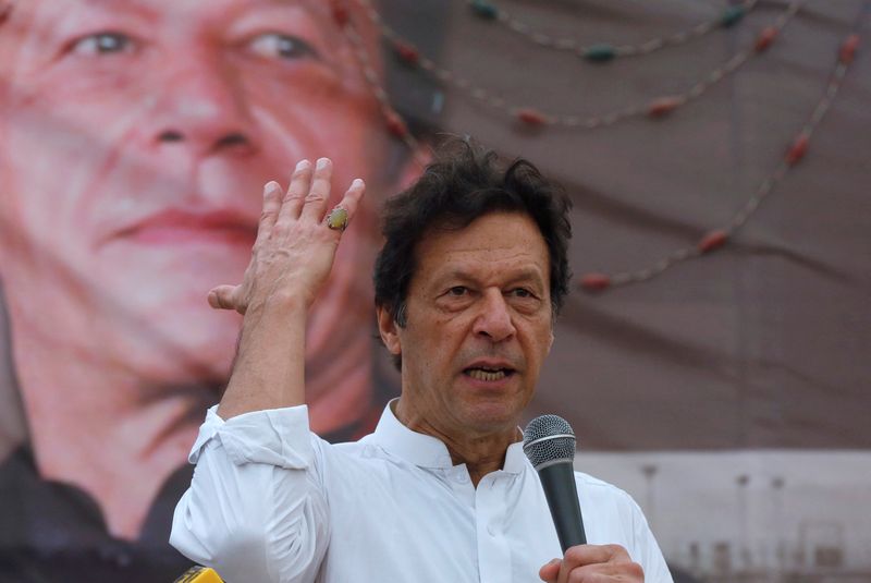 FILE PHOTO: PTI chairman Imran Khan  gestures while addressing