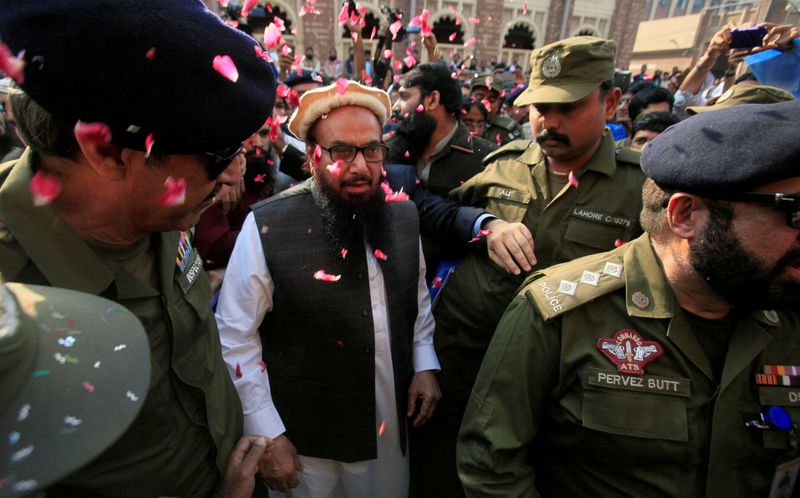 FILE PHOTO: Hafiz Saeed is showered with flower petals as