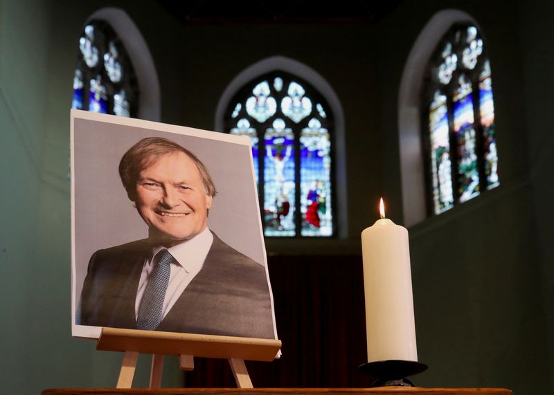 FILE PHOTO: A candle and a portrait of British MP