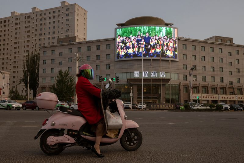 A screen shows a picture of Chinese President Xi Jinping
