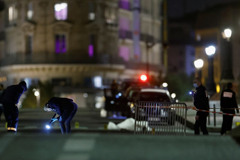 French police forensic officers inspect the scene of a shooting