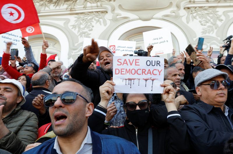 Demonstrators shout slogans during a protest against Tunisian President Kais