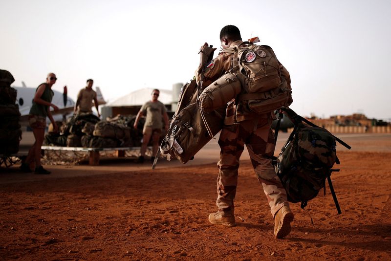 FILE PHOTO: A French soldier leaves with his backpack at