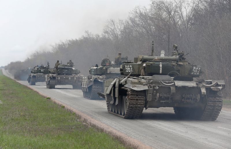 Tanks of pro-Russian troops drive along a road near Mariupol