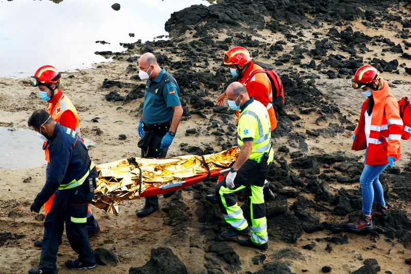 FILE PHOTO: Rescue workers carry the body of a dead