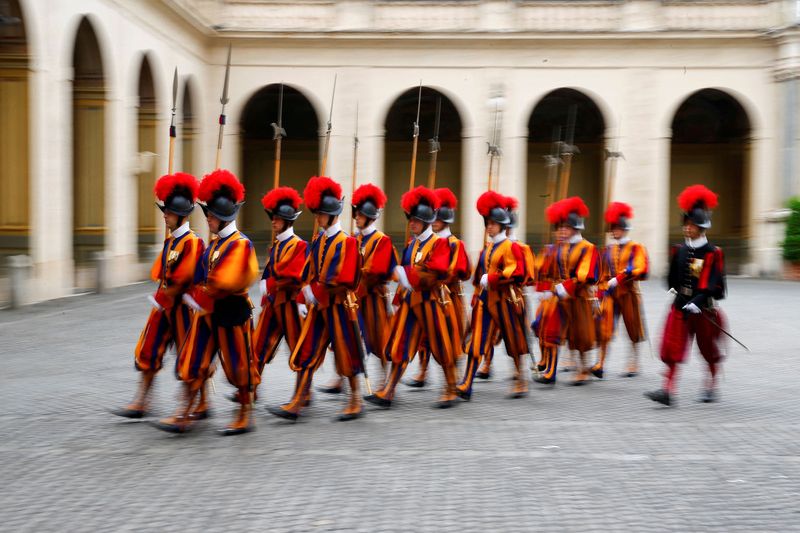 FILE PHOTO: Swiss guards march at the Vatican