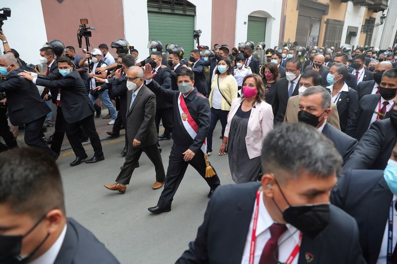 FILE PHOTO: Peru’s President Pedro Castillo waves as he walks