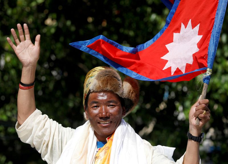 FILE PHOTO: Nepali mountaineer Kami Rita Sherpa waves towards media
