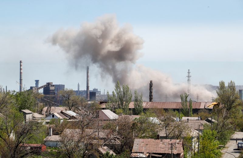 Smoke rises above a plant of Azovstal Iron and Steel