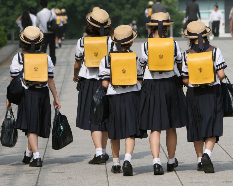 FILE PHOTO: Children walk on way back from school in