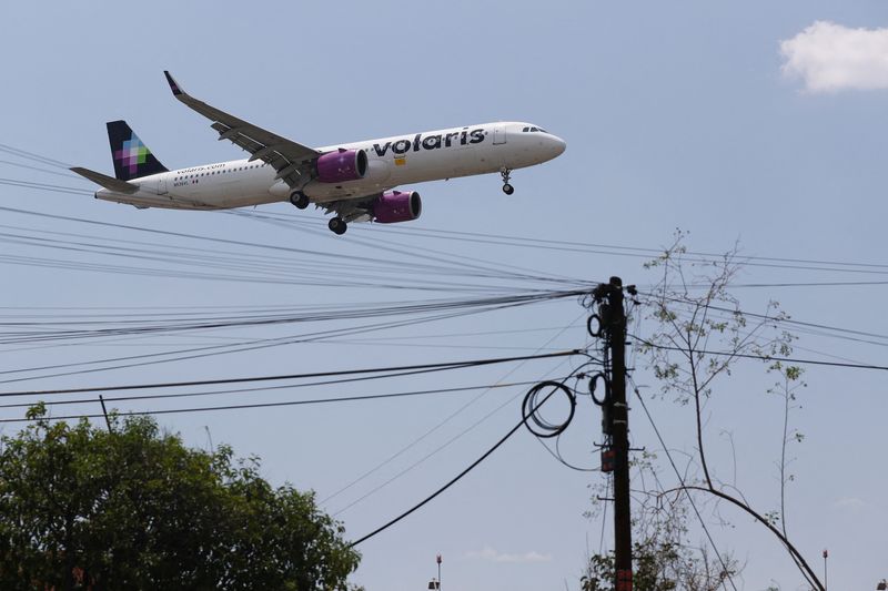 A Volaris airplane prepares to land on the airstrip at