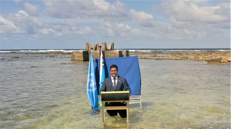 Tuvalu’s Foreign Minister Simon Kofe gives a COP26 statement while