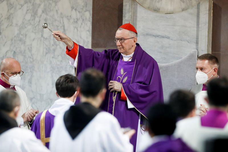 Vatican’s Secretary of State sprinkles holy water during a mass