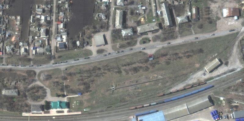 A satellite image shows convoy of military forces heading south