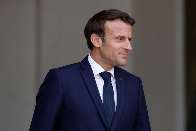 French President Emmanuel Macron welcomes a guest at the Elysee